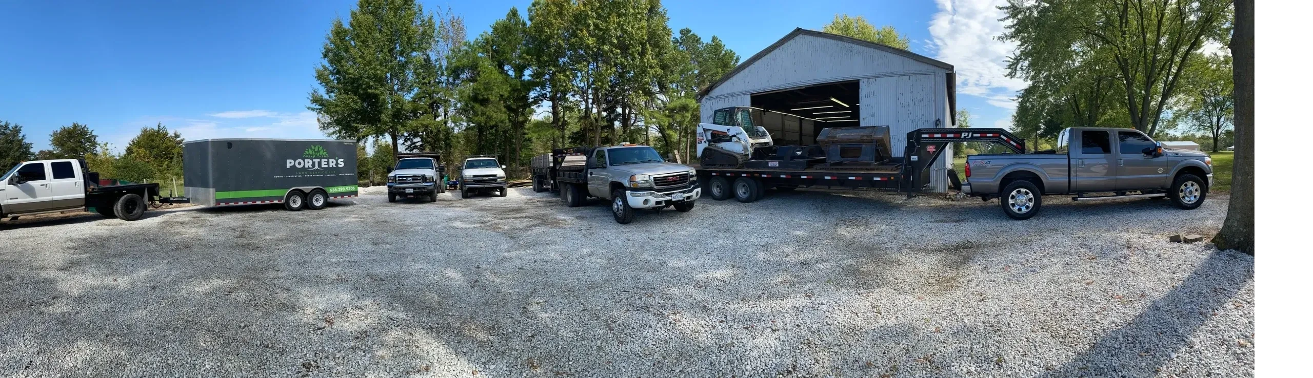 Porter's Lawn Service professional lawn care fleet in St. Louis, MO showing company driveway with fleet of trucks and equipment ready for lawn care jobs