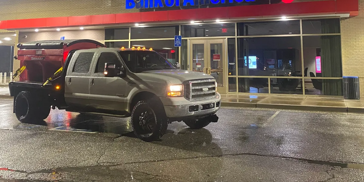 Professional residential snow removal service in St. Louis, MO showing heavy duty truck outside business after successful snow cleanup