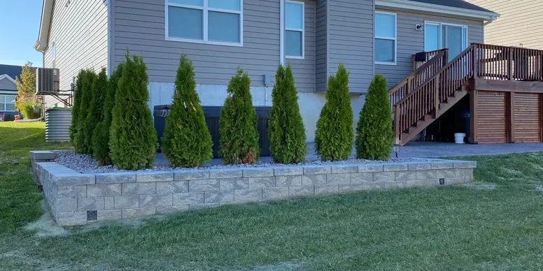 Professional landscaping service in St. Louis, MO showing beautifully designed outdoor space with plantings and hardscape