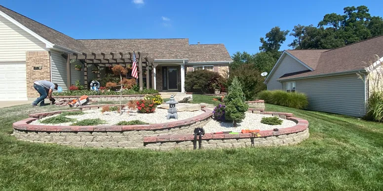 Professional outdoor lighting installation in St. Louis, MO showing retaining walls and landscape lighting in well-landscaped backyard